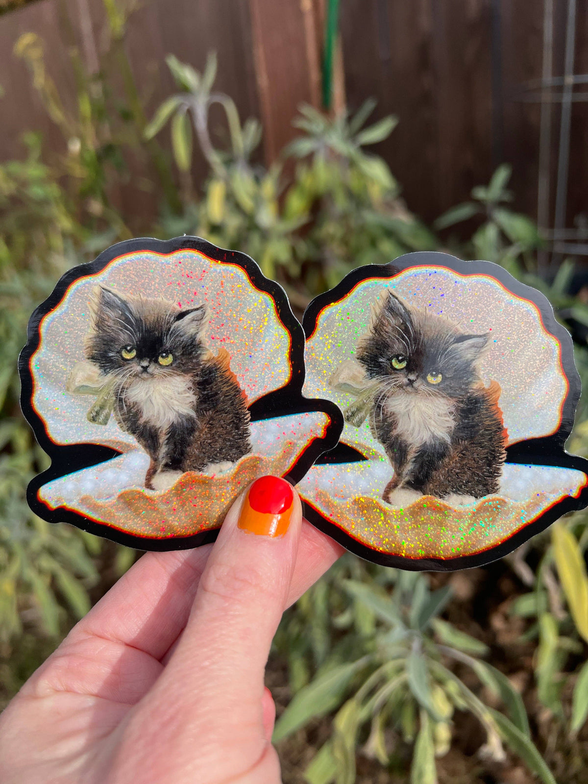 Two 3-inch tuxedo cat seashell stickers with glittery iridescent edges