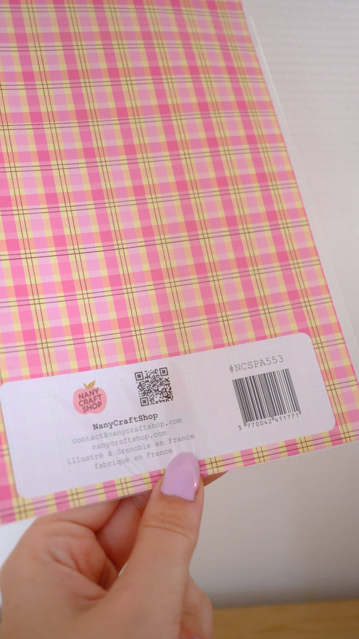 Back of A5 sticker sheet with pink and yellow plaid pattern and product label