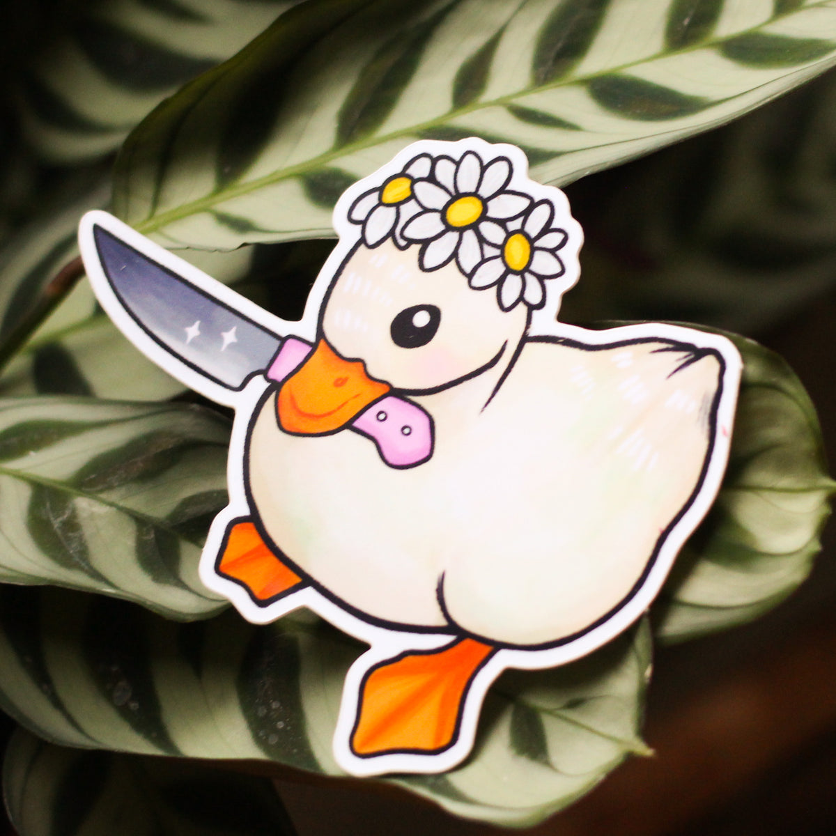 White cartoon vinyl sticker with flower crown, orange shoes, and purple heart.