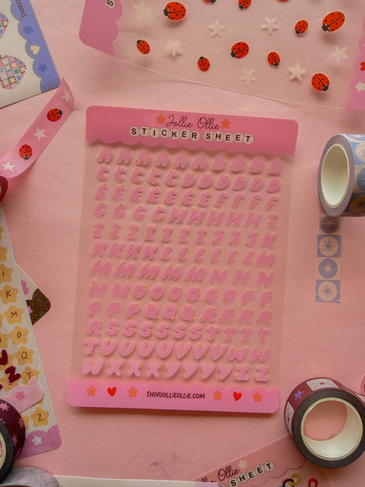 Pink bubble letter sticker sheet with raised alphabet letters and small heart accents