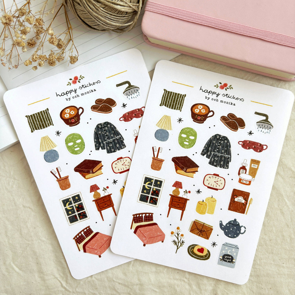 Bedtime sticker sheets laid open, featuring pajamas, teapot, books, and drinks