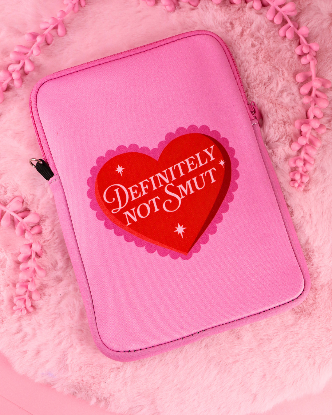 Definitely Not Smut e-reader sleeve, pink, closed zip and heart logo badge