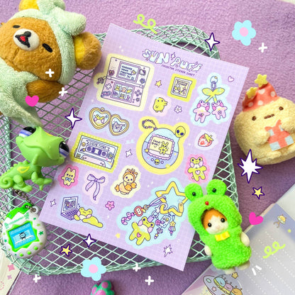 Pastel purple sticker sheet with cute animal figures, hearts, stars, and swirls
