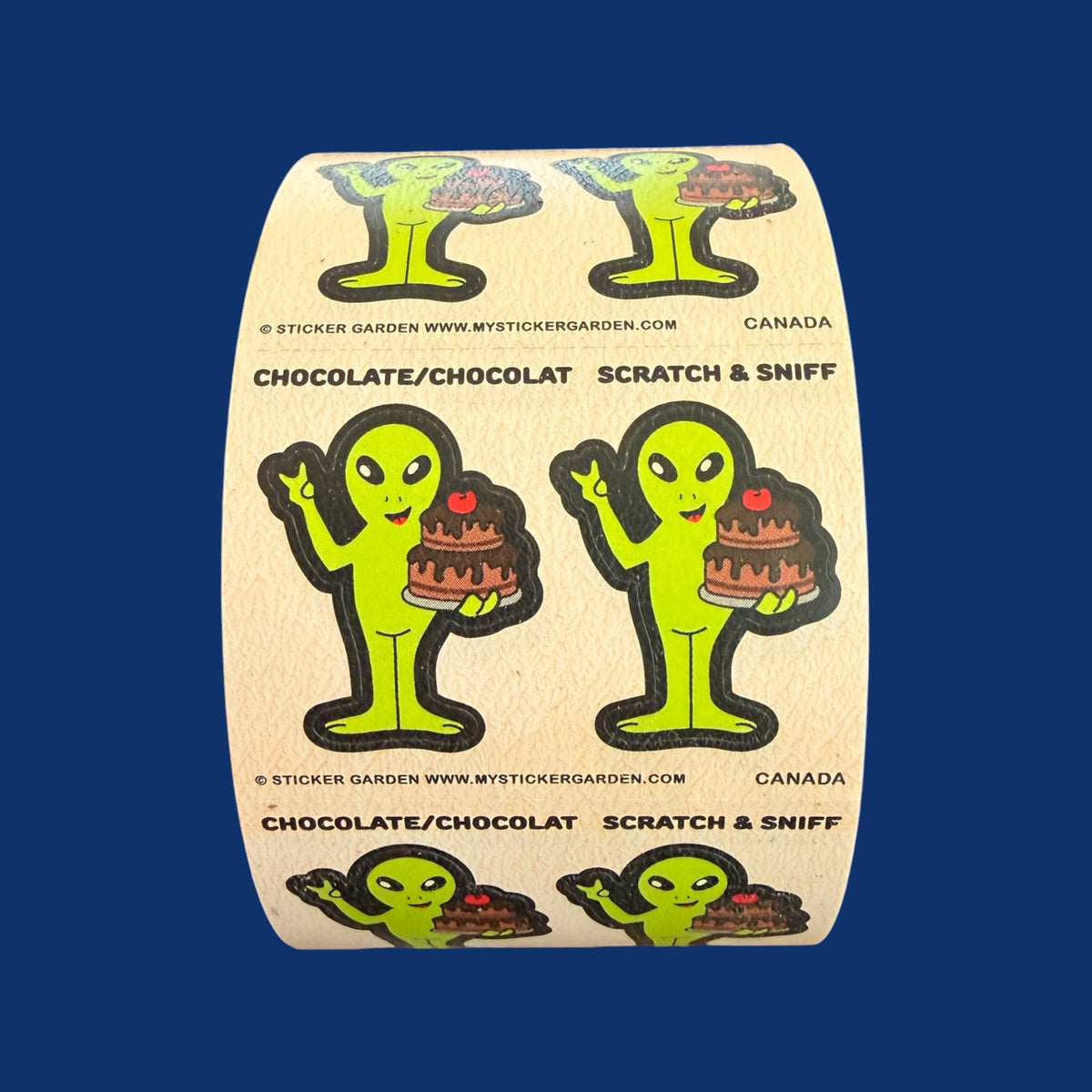 Scratch & sniff sticker roll featuring green alien characters with chocolate cake illustration