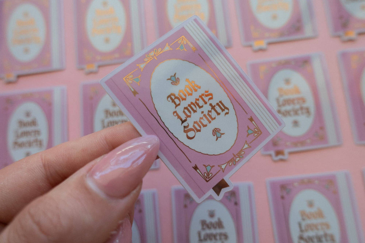Vinyl sticker with pink frame and gold "Book Lover's Society" lettering