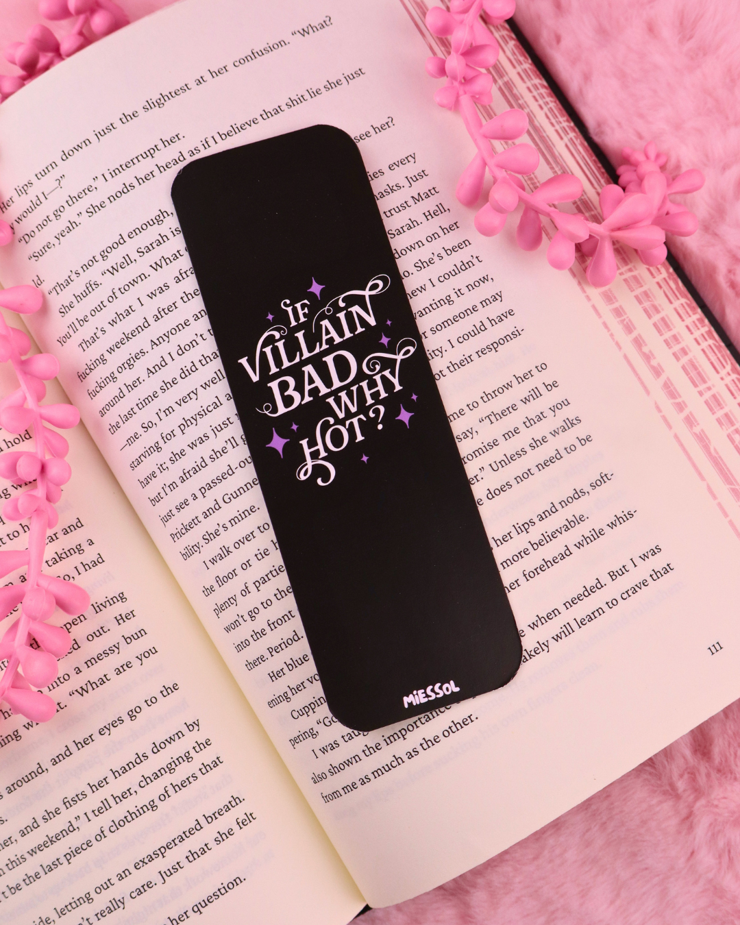 Black bookmark with purple "If Villain Bad Why Hot?" design centered on book pages