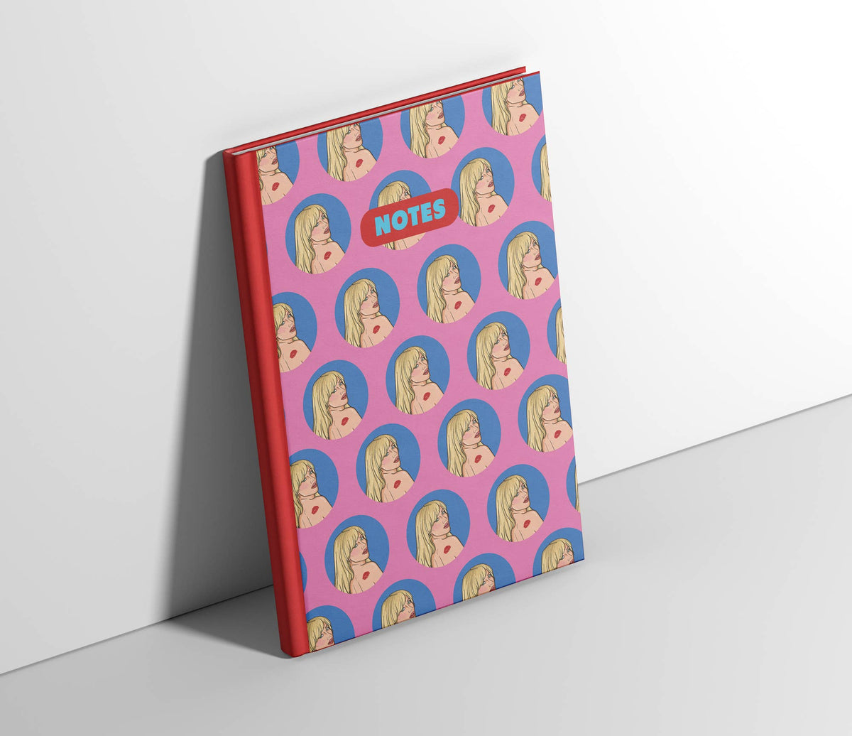 A5 notebook angled display with purple patterned cover, red spine edge, “NOTES” badge.