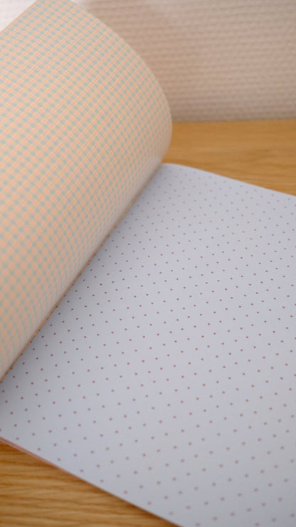 Scrapbook paper sheet with tiny dot pattern on pale lavender and beige