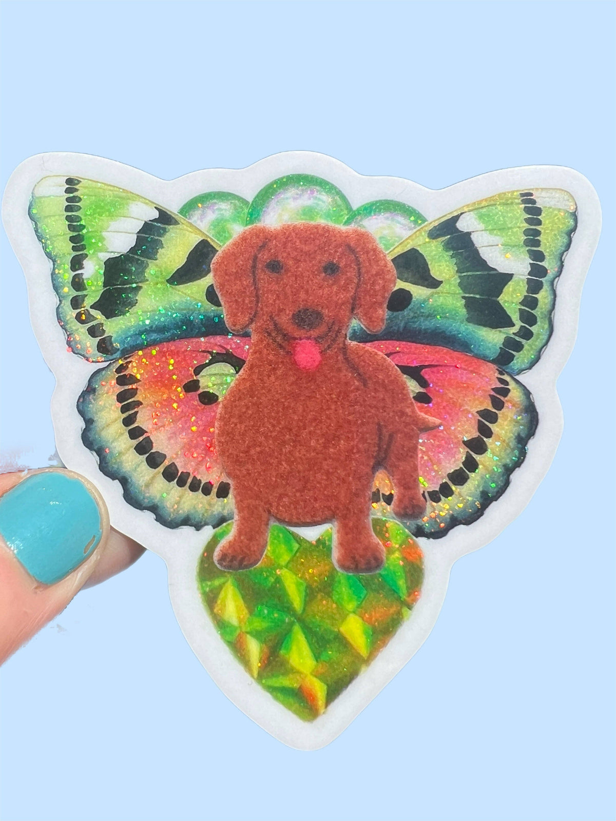 Butterfly dachshund sticker featuring an orange dog in front of glittering multicolor wings