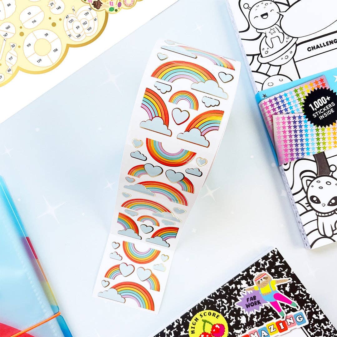 Rainbow sticker strip with cloud and heart icons laid out on white