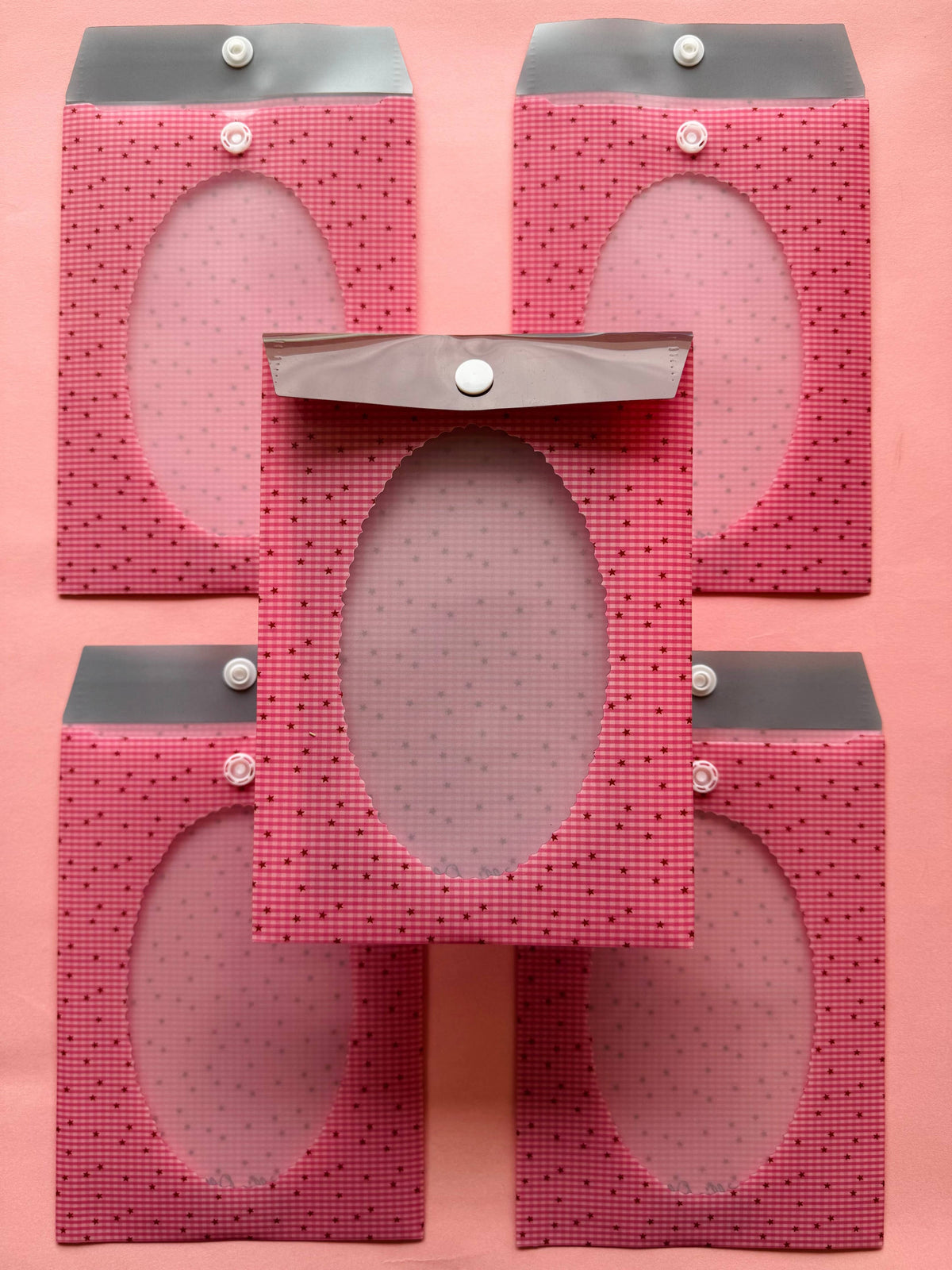 Pink gingham envelope sleeve with oval window and snap buttons