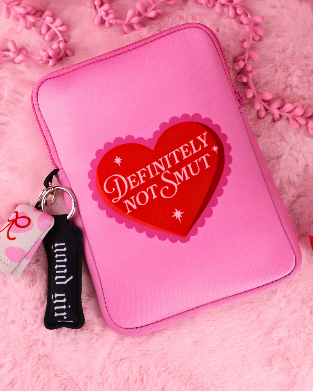 Definitely Not Smut e-reader sleeve, pink, zip-top with heart logo and keychain