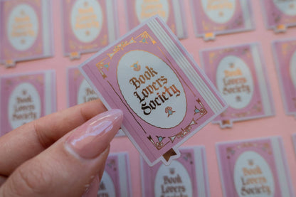 Vinyl sticker with pink frame and gold "Book Lover's Society" lettering