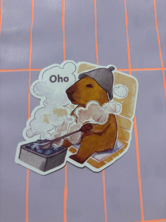 Vinyl sticker of a capybara in sauna with steam clouds and 'Oho' speech text