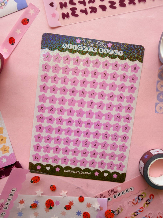 Pink letter sticker sheet with glitter-style alphabet characters and heart accents
