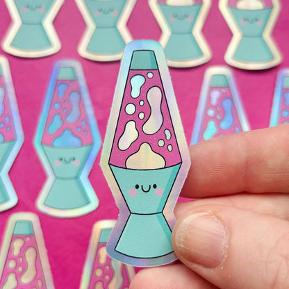 Holographic lava lamp vinyl sticker with teal base, purple lava and smiley face; finger-held