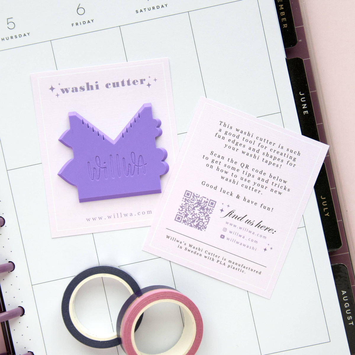 Washi cutter set with a purple house-shaped cutter and washi tape rolls on a planner page