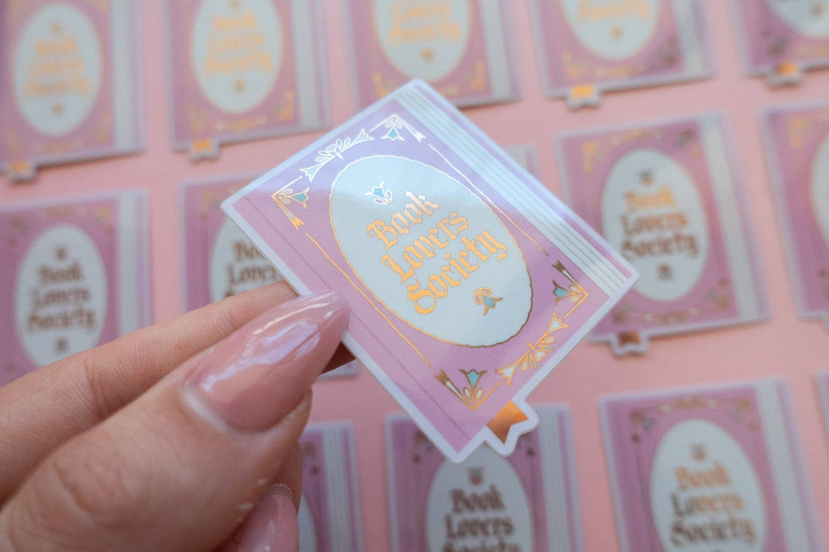 Vinyl sticker with light blue frame and gold "Book Lover's Society" lettering
