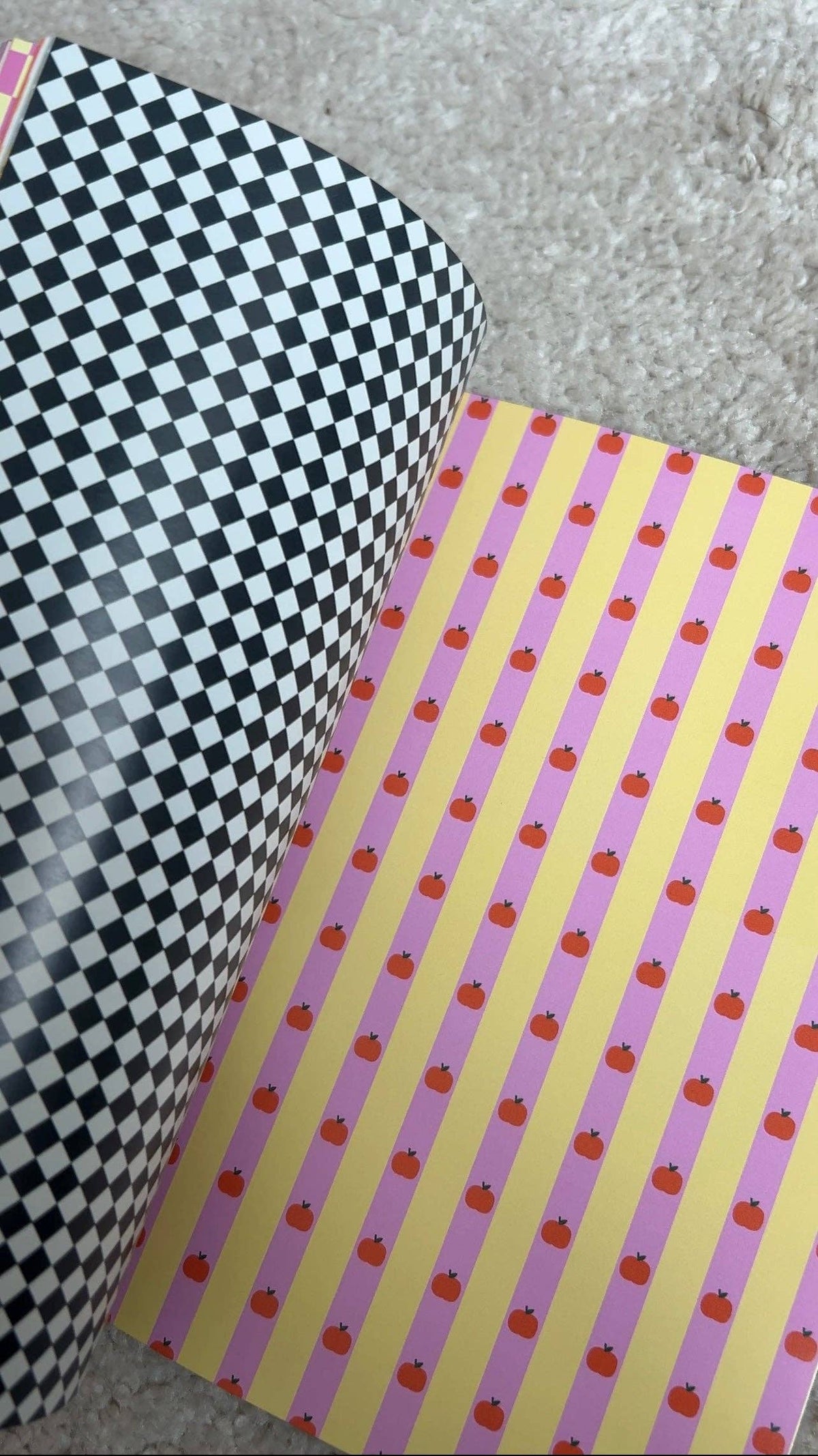 Scrapbook paper stack, black checker page and pink vertical stripe page