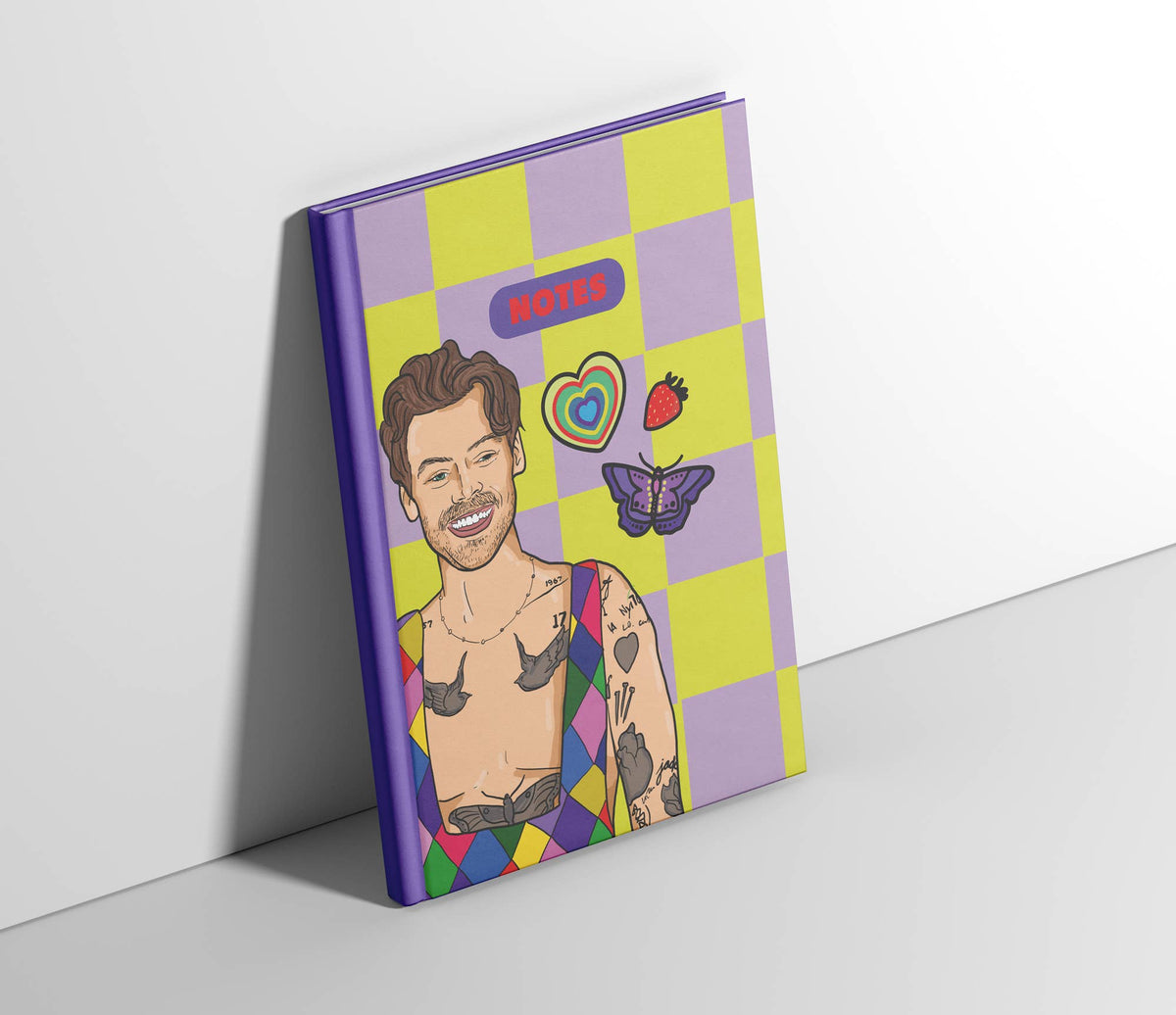 A5 notebook cover in purple and yellow squares with “NOTES” badge and character art