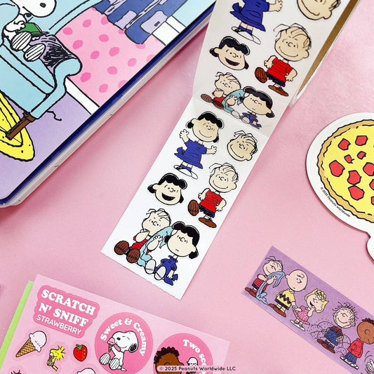 Sticker roll with Lucy and Linus character designs on a white sheet