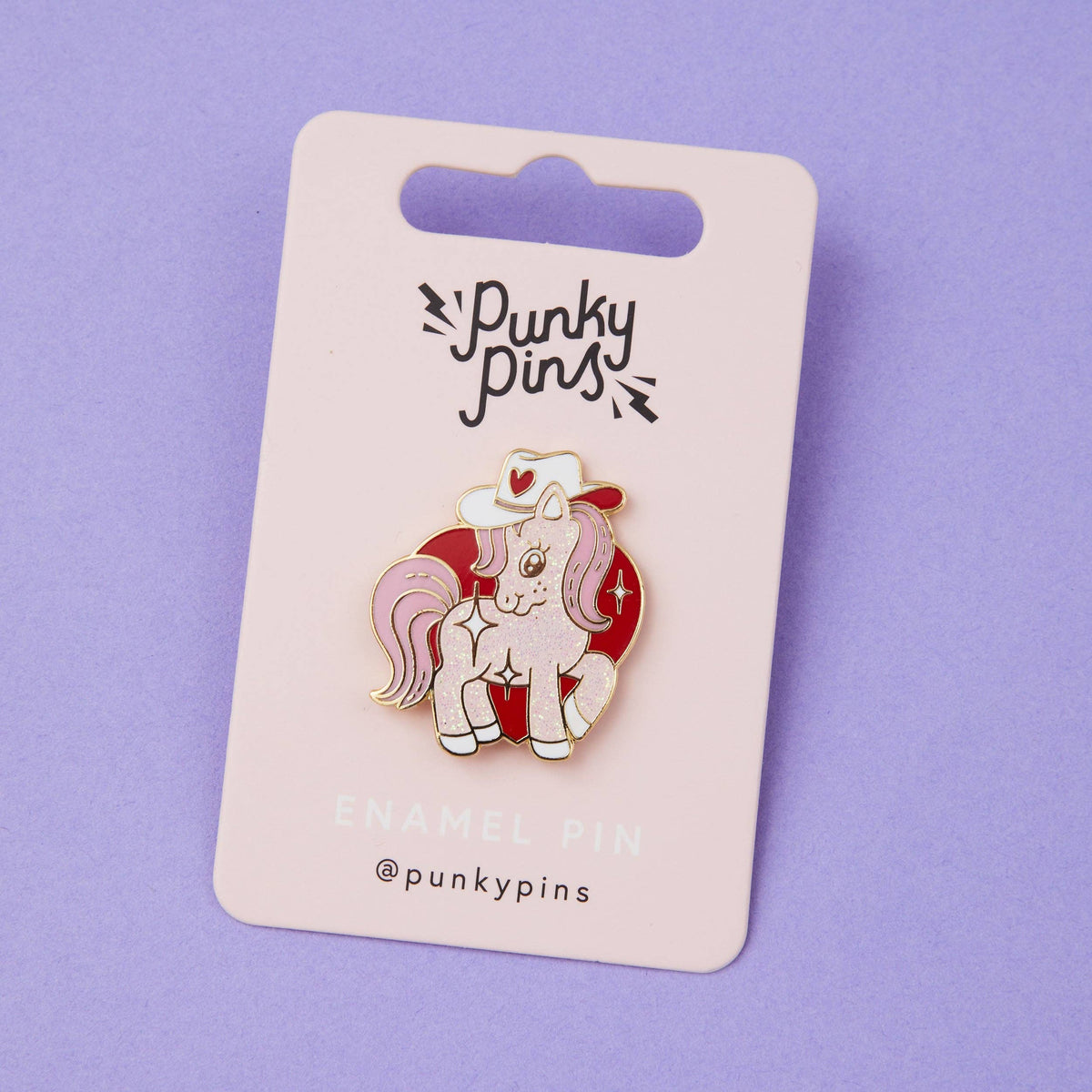 Cowgirl pony enamel pin on Punky Pins card, white unicorn with red cowboy hat and hearts