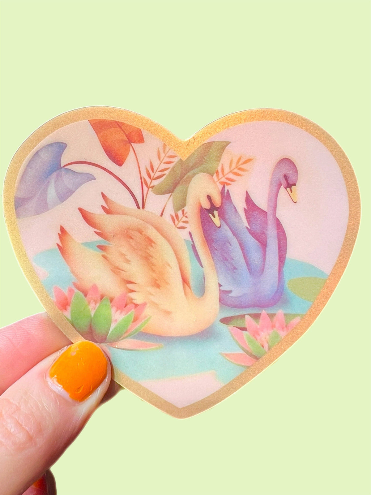 Heart-shaped Swan Friends sticker, 3 inch, featuring swans, leaves, and flowers