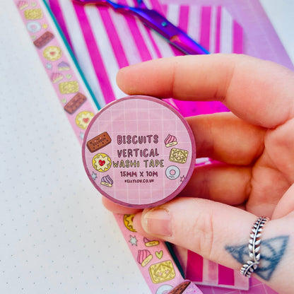Pastel vertical washi tape roll with biscuit icons, held in hand