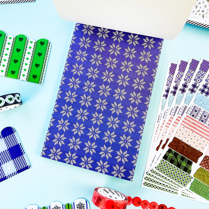Blue winter sticker sheet with repeating white snowflake pattern and assorted cutout stickers
