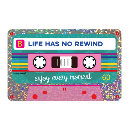 Glitter cassette tape sticker with colorful stripes and text 'Life has no rewind'.