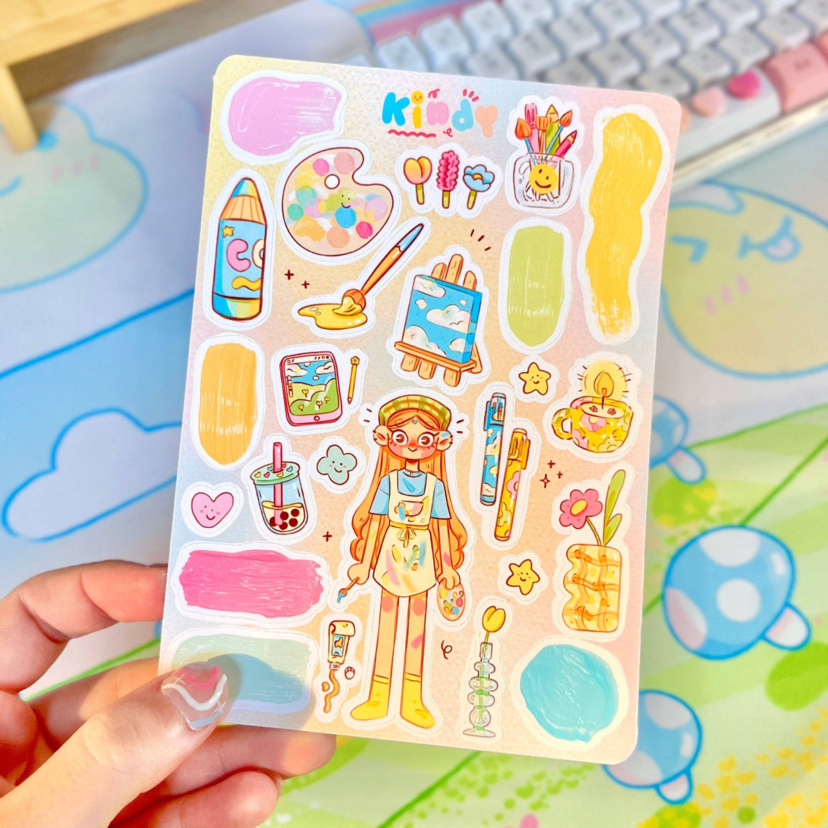 Kids sticker sheet held in hand with cartoon artist girl, paints, and stationery icons