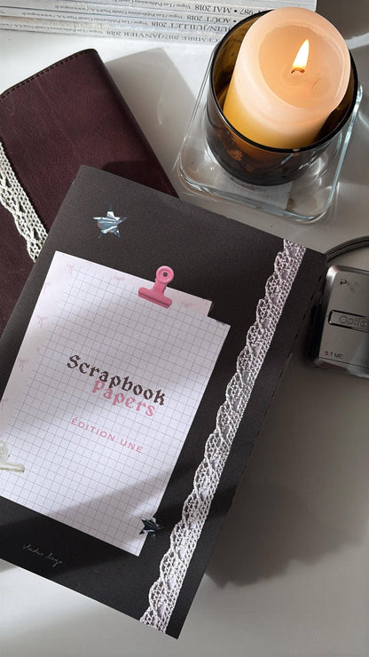 Scrapbook paper stack with maroon pages, lace trim, star and pink binder clip label