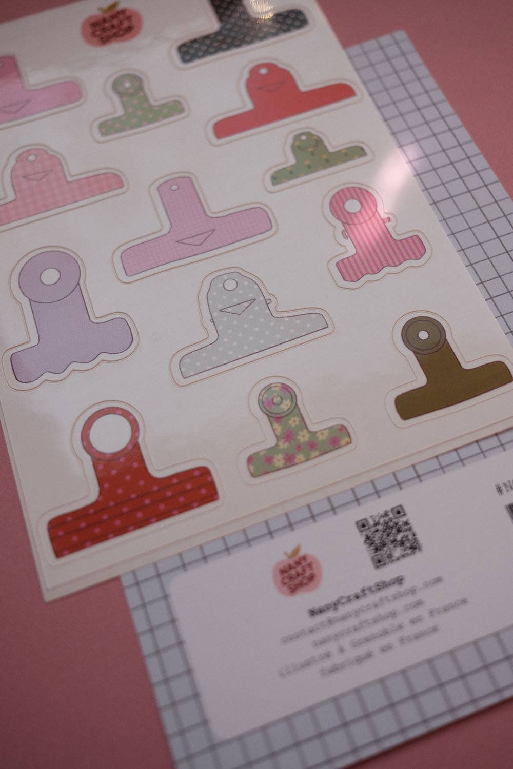 Board clamps sticker sheet with multiple T-shaped pieces and grid ruler underneath