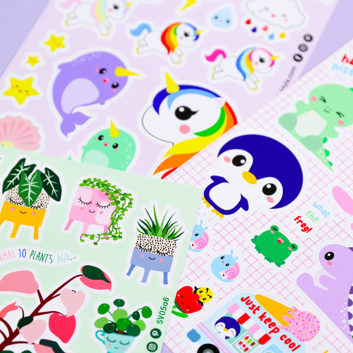 Sticker sheet close-up with penguin characters, plants in pots, and colorful animal stickers