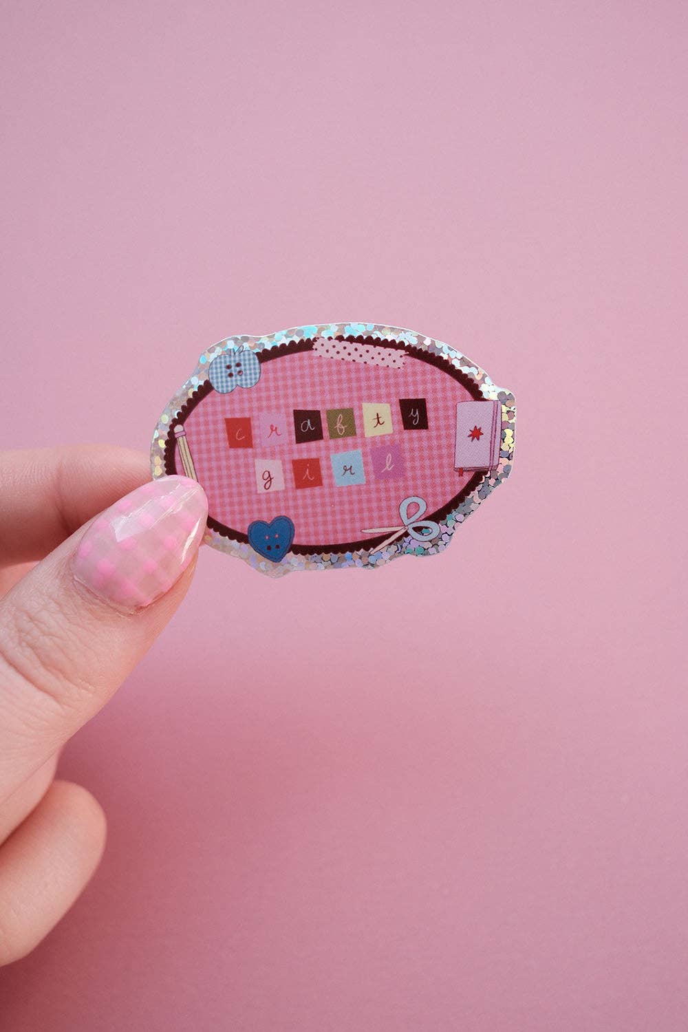 Clever girl sticker held in hand, oval fabric design with letter tiles and bow