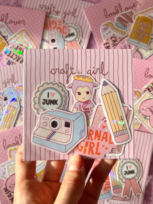 Crafty girl sticker pack: camera and girl stickers with round 'JUNK' badges, in hand
