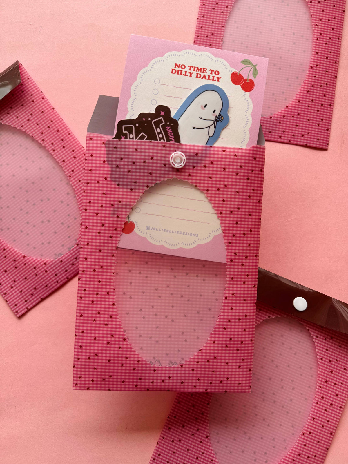 Pink gingham envelope sleeve with snap closure and label pocket