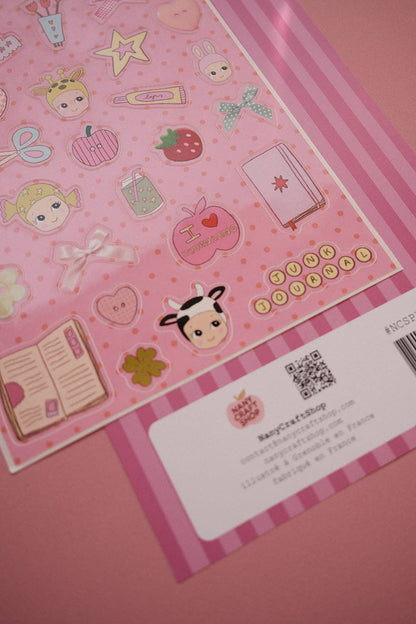Pink A5 sticker sheet with hearts, books, stars, strawberry icons, and barcode card