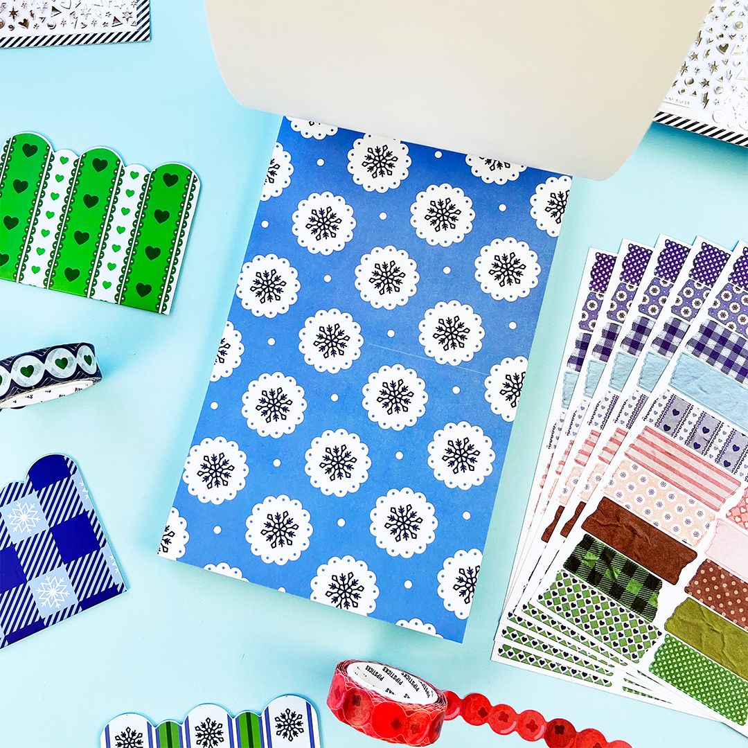 Sheet of blue snowflake stickers with white circular snowflake rosettes and scattered dots
