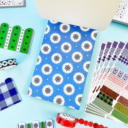 Sheet of blue snowflake stickers with white circular snowflake rosettes and scattered dots