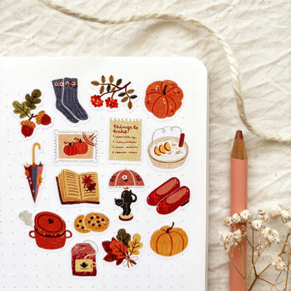 Autumn sticker sheet with kettle, pumpkins, leaves, boots, and cookies icons on white