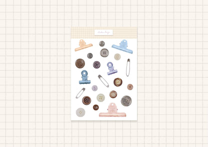 Button-themed sticker sheet with pastel clips, needles, and round button icons