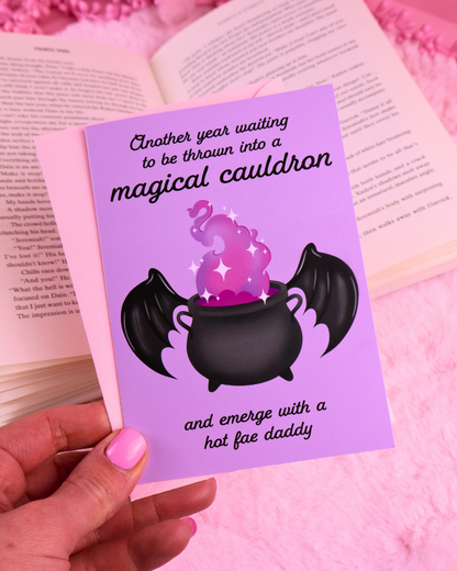 Purple birthday card with black cauldron, bat wings, and “magical cauldron” text.