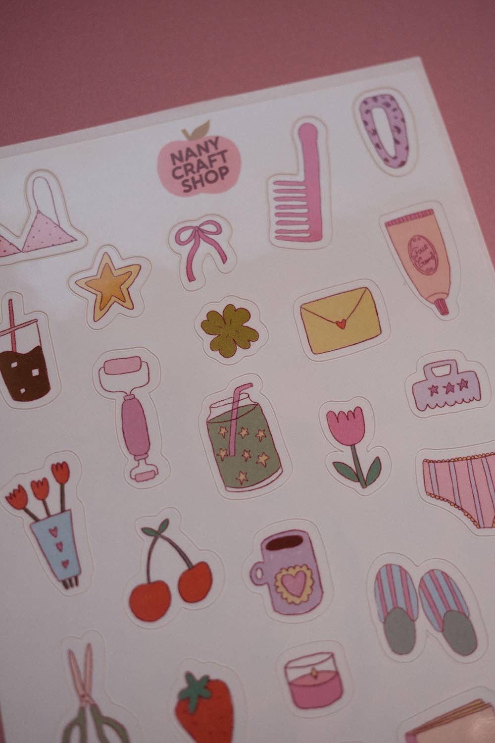 Close-up sticker sheet with girly icons: star, striped top, envelope, tulip, and hearts