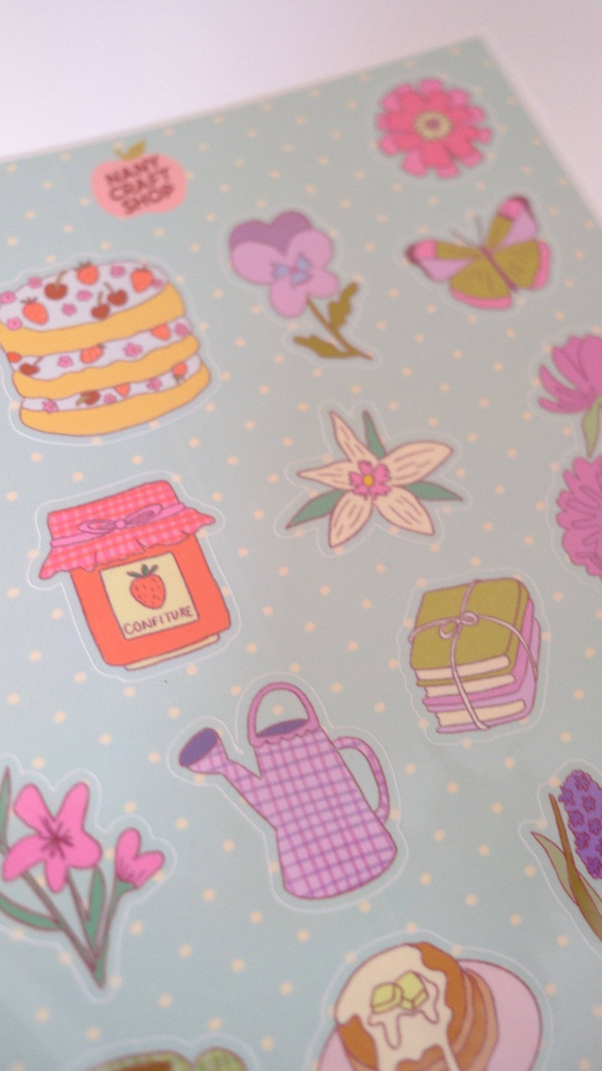Close-up of A5 picnic sticker sheet with flowers, cake, watering can, and jar stickers