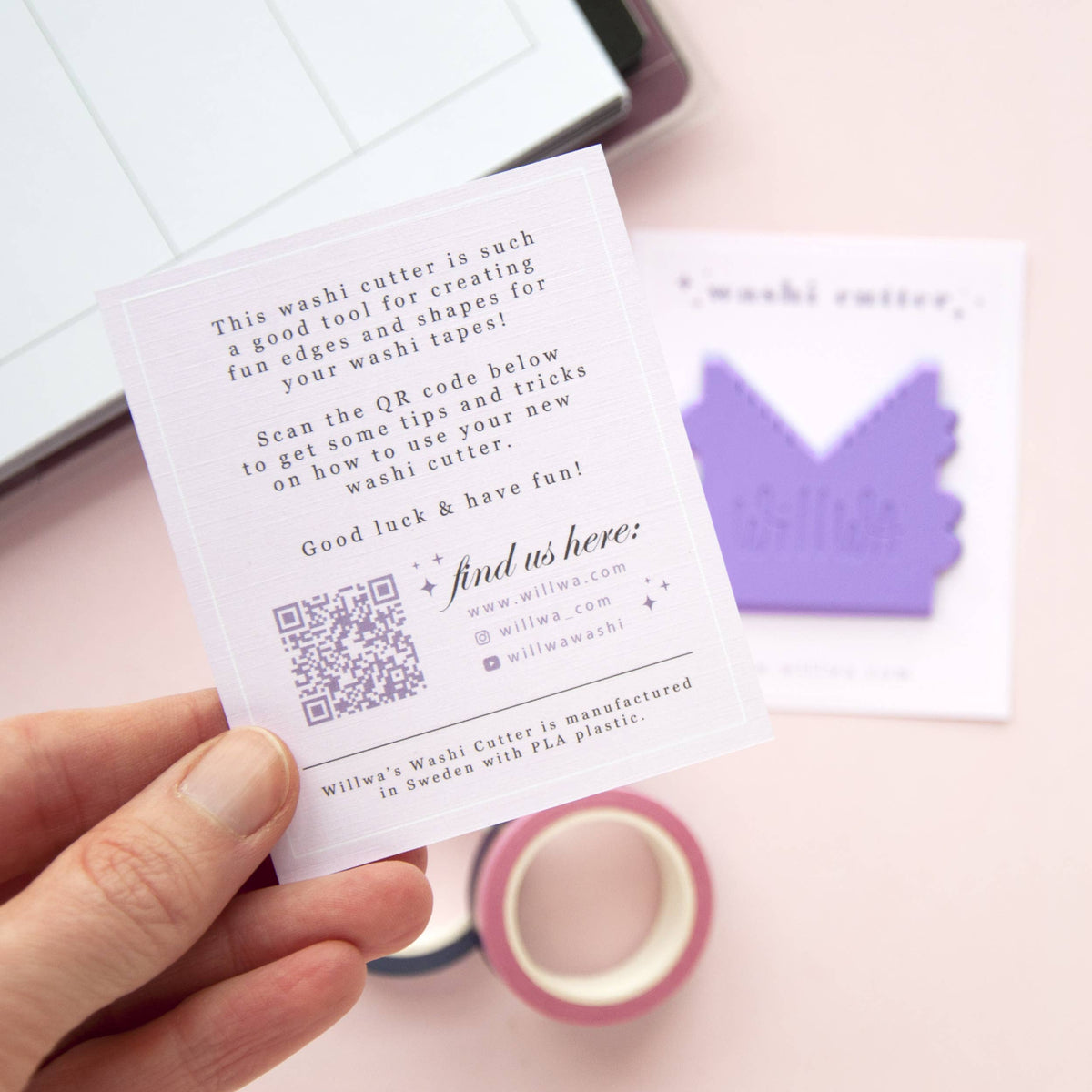 Hand holding a “washi cutter” instruction card beside a purple house-shaped cutter