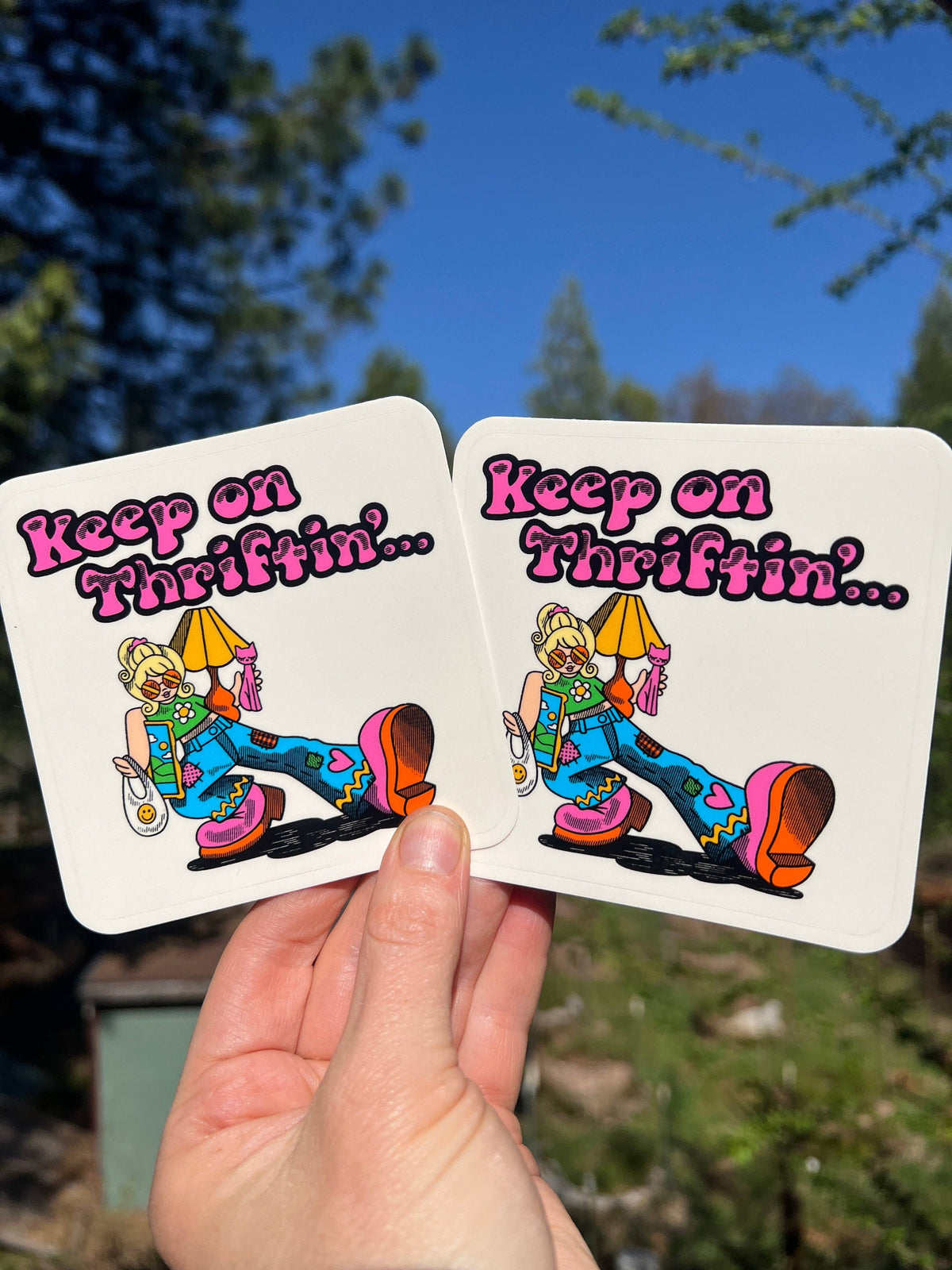 Set of 2 3-inch rectangular Keep on Thriftnin stickers with cartoon figure and text
