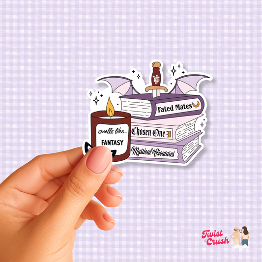 Fantasy book lover sticker featuring stacked books, bat wings, and candles, held by hand