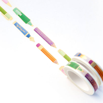 Washi tape roll with pen-themed strips; visible blue, green, orange, and purple tails