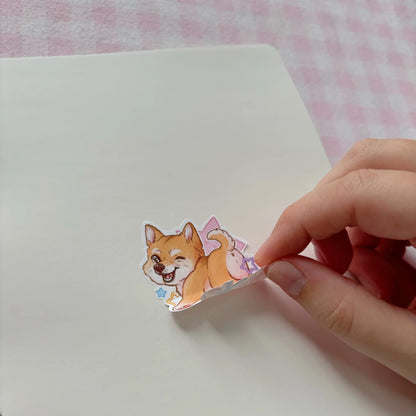 Cat sticker being placed on a white page by hand in a reusable sticker book